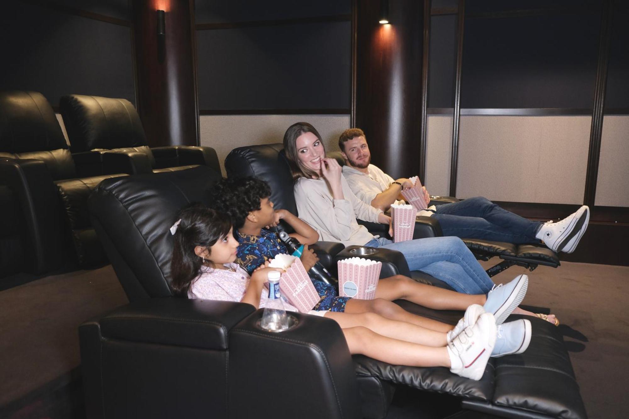 Charthouse Bahrain Hotel Manama Exterior foto A family watching a movie in a home theater